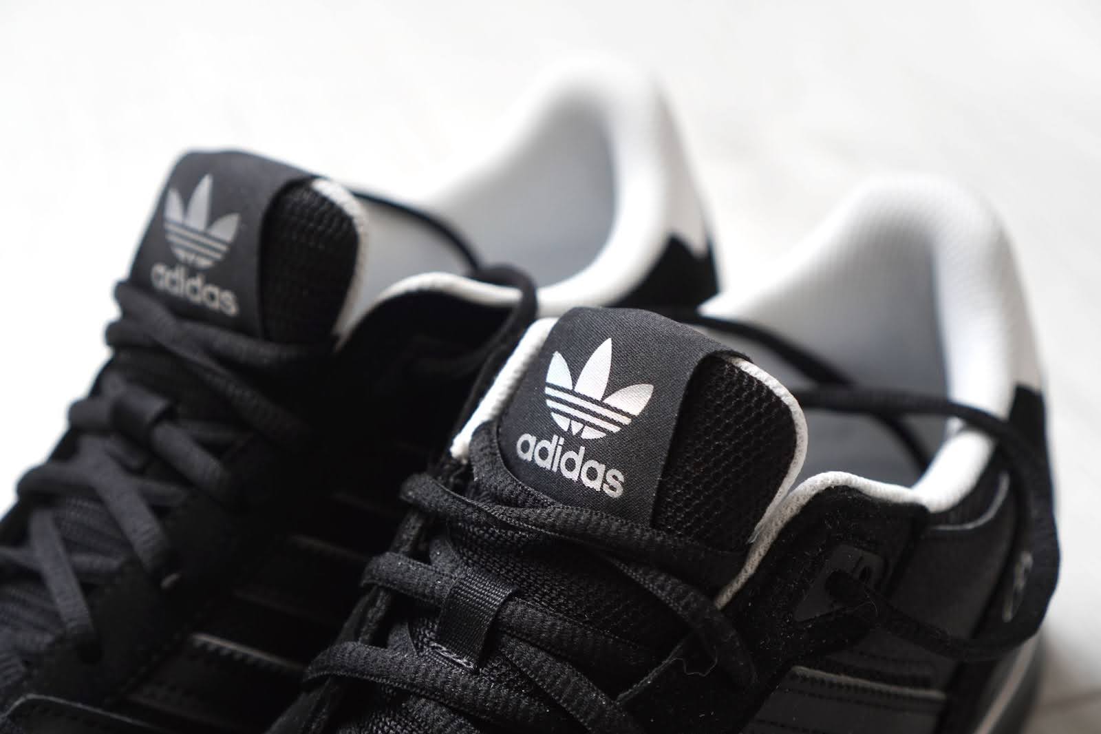 Black Adidas shoes that run big up close.