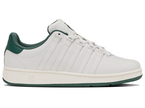 White sneaker with green accents on a white background