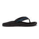 OluKai ʻOhana Pālua sandals in black with blue accents, featuring a comfortable contoured footbed and durable outsole, side view.