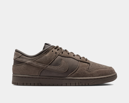 Nike Dunk Low Retro SE sneakers in dark brown with suede overlays, perforated toe box, and tonal leather accents, side view.