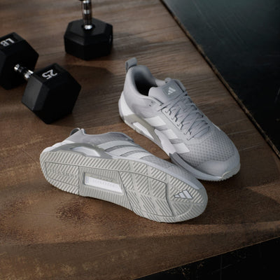 Adidas Dropset Control Trainer training shoes in light gray with mesh upper, lace closure, and durable outsole, lifestyle gym view.