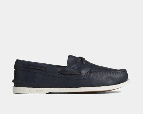 Navy blue leather boat shoe on a light gray background