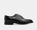 Johnston & Murphy Melton Cap Toe dress shoes in black leather with classic cap toe design and lace-up closure, side profile view.