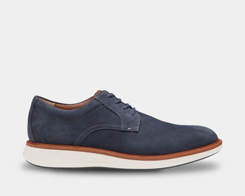Johnston & Murphy XC+ Parker shoes in navy nubuck leather with contrast tan midsole and white outsole, side view.
