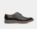 Johnston & Murphy Upton Wingtip dress shoes in black leather with brogue detailing and contrast stitching, side view.