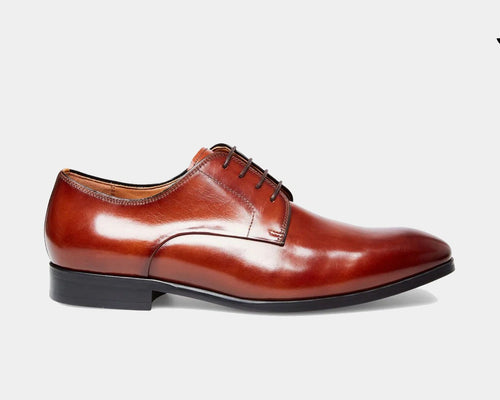Steve Madden Parsens dress shoes in polished brown leather with a sleek lace-up design, side view.